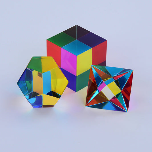 Three translucent CMY solids producing dozens of distinct colours where their faces overlap in sunlight