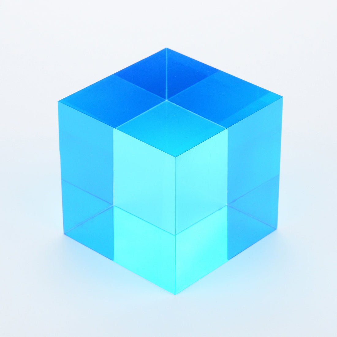 A single cyan cube, one of the cool colours most people describe as calming, on a white surface